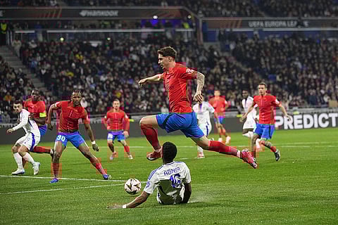 Europa League 2024-25: FSBC's David Miculescu is tackled by Lyon's Abner