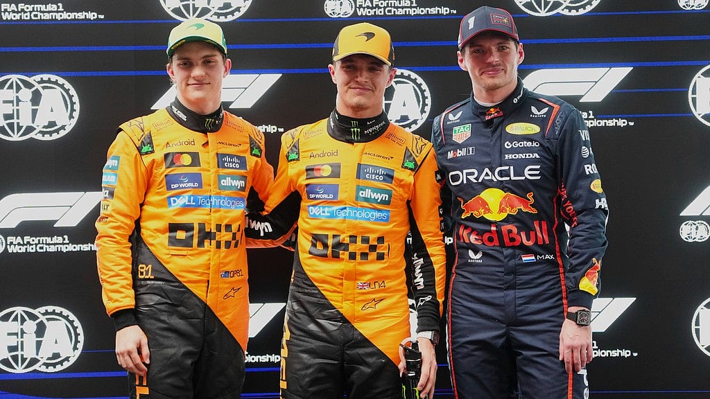 Photo: AP : McLaren driver Lando Norris (centre) poses after taking pole position with second-placed teammate Oscar Piastri, left, and third-placed Red Bull driver Max Verstappen at the Australian Grand Prix.