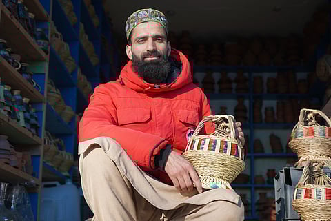 Sheikh Dawood at his shop with a Kanger