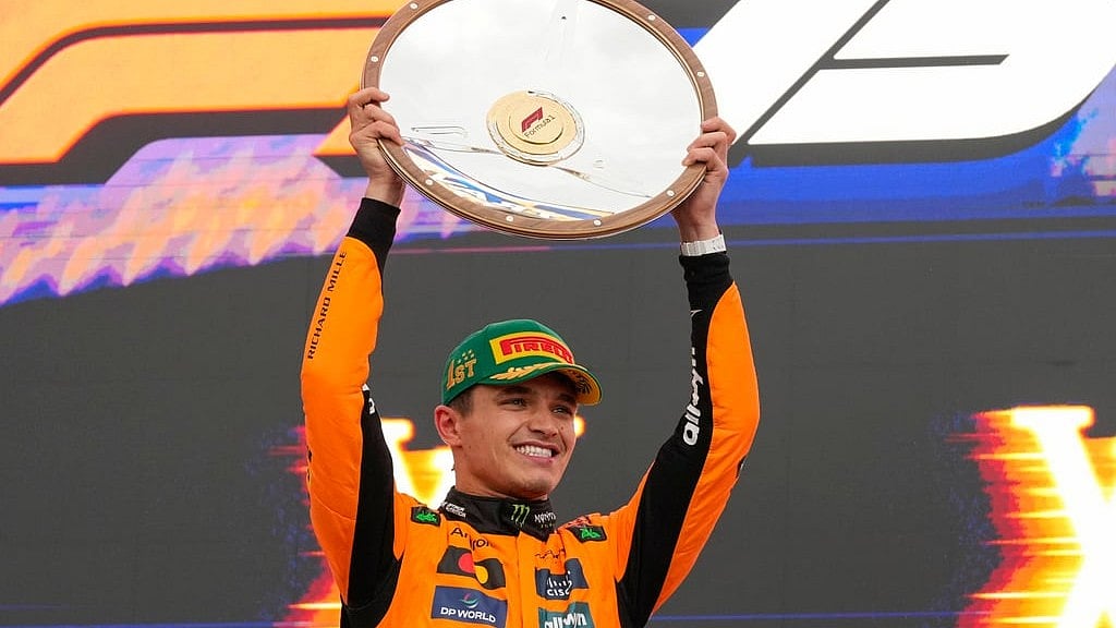 AP/Asanka Brendon Ratnayake : McLaren driver Lando Norris of Britain celebrates on the podium after winning the Australian Formula One Grand Prix at Albert Park, in Melbourne.