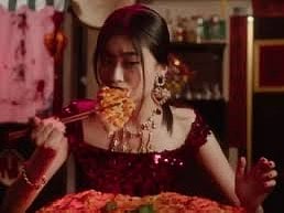 Chinese woman eating pizza with chopsticks 