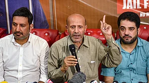 PTI : Member Parliament and Awami Ittehad Party (AIP) chief Sheikh Abdul Rashid (in middle), popularly known as Engineer Rashid, addresses a press conference ahead of the Jammu and Kashmir Assembly elections, in Srinagar.