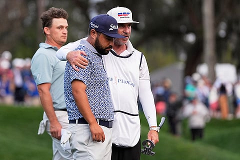 Players Championship Golf: J.J. Spaun, center, reacts after a putt on the 18th green