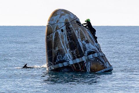 SpaceX Stuck Astronauts: A support team member works on the SpaceX capsule shortly after it landed