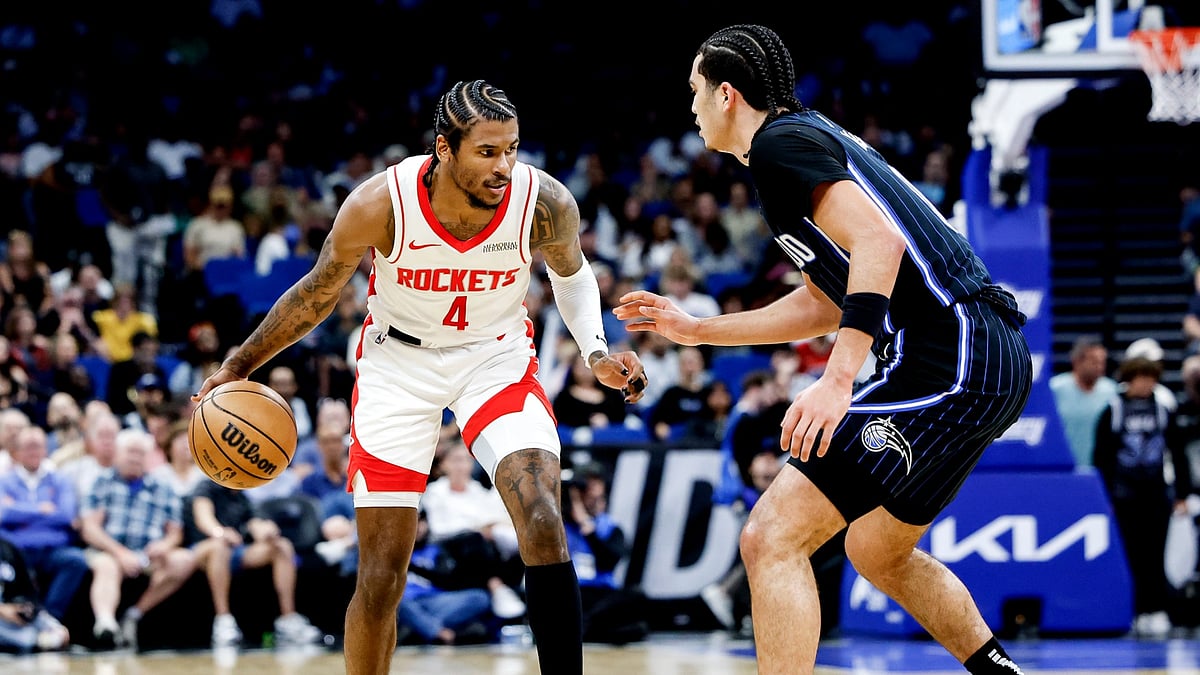 Jalen Green #4 of the Houston Rockets is defended by Anthony Black  of the Orlando Magic during the first half of the game at the Kia Center on March 19, 2025 in Orlando, Florida. The Rockets defeated the Magic 116 to 108