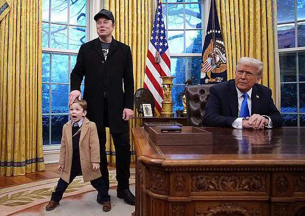 Andrew Harnik/Getty Images : Tesla and SpaceX CEO Elon Musk, joined by his son X, delivers remarks alongside U.S. President Donald Trump during an executive order signing in the Oval Office at the White House on February 11, 2025 in Washington, DC. Trump is to sign an executive order implementing the Department of Government Efficiency’s (DOGE) "workforce optimization initiative," which, according to Trump, will encourage agencies to limit hiring and reduce the size of the federal government. 