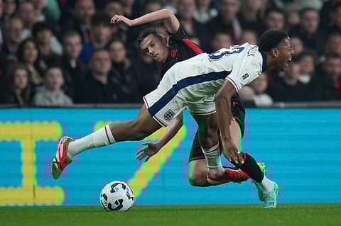 England's Myles Lewis-Kelly is tackled by Albania's Jasir Asani during a World Cup qualifying soccer match between England and Albania at Wembley stadium in London, Friday, March 21, 2025.