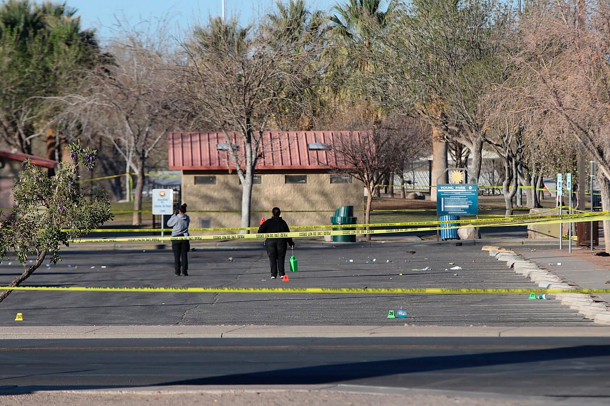 Jusin Garcia / Albuquerque Journal  via AP : Crime scene technicians look over the Young Park parking lot after a mass shooting overnight, Saturday, March 22, 2025 in Las Cruces, New Mexico
