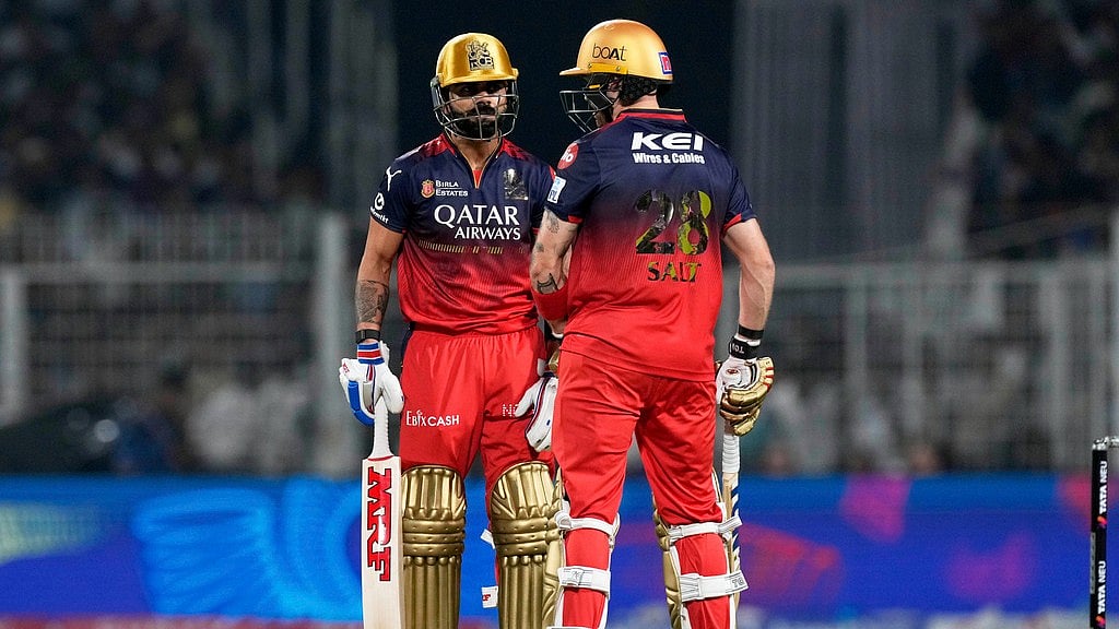 Phil Salt, left, and batting partner Virat Kohli have a chat during the Indian Premier League cricket match on Saturday. - AP/Bikas Das