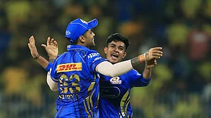 AP Photo/R. Parthibhan : Mumbai Indians' Vignesh Puthur, right, and captain Suryakumar Yadav celebrate the dismissal of Chennai Super Kings' captain Ruturaj Gaikwad during the Indian Premier League cricket match between Chennai Super Kings and Mumbai Indians in Chennai.