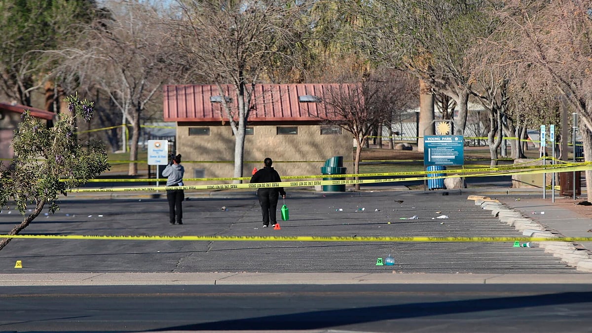 Jusin Garcia / Albuquerque Journal  via AP : Crime scene technicians look over the Young Park parking lot after a mass shooting overnight, Saturday, March 22, 2025 in Las Cruces, New Mexico
