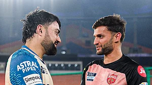 Photo: X | Gujarat Titans : Punjab Kings all-rounder Azmatullah Omarzai (R) with Gujarat Titans spinner Rashid Khan.