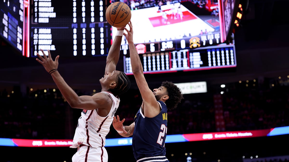 Amen Thompson of the Houston Rockets battles Jamal Murray for a rebound