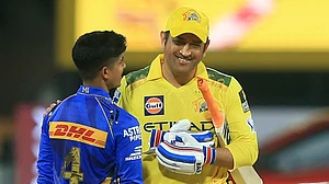 AP Photo/R. Parthibhan : Chennai Super Kings' Mahendra Singh Dhoni, right, talks to Mumbai Indians' young debutant Vignesh Puthur after Chennai Super Kings won the Indian Premier League cricket match against Mumbai Indians in Chennai.