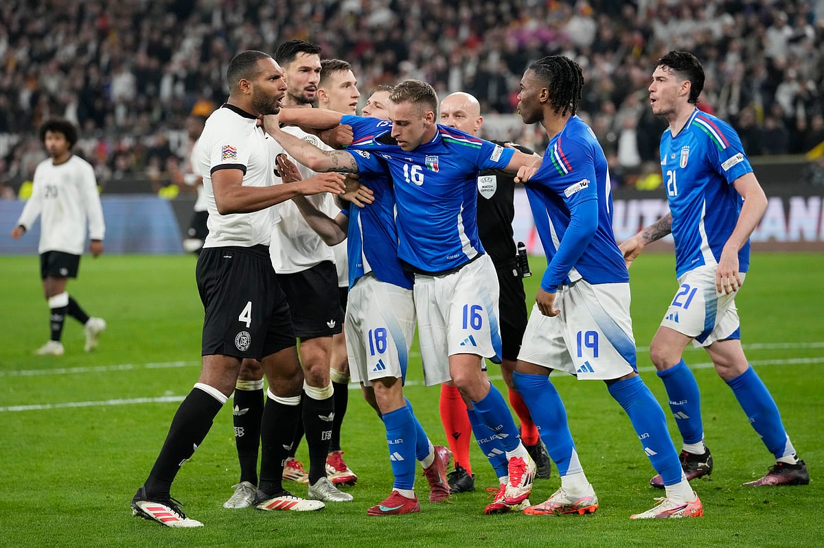 Italy's Davide Frattesi, centre, Destiny Udogie, second from right, and Nicolo Barella, centre left, argue with Germany's Jonathan Tah, left, during the Nations League quarterfinal second leg soccer match between Germany and Italy at the Signal-Iduna Park in Dortmund, Germany, Sunday, March 23, 2025.  - (AP Photo/Martin Meissner)