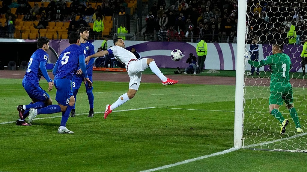 Photo: AP : Iran's Mehdi Taremi, centre, scores his side's second goal during a World Cup 2026 group A qualifying match against Uzbekistan.