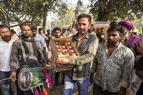 Devotees offer alchohol at Baba Rode Shah Mazar