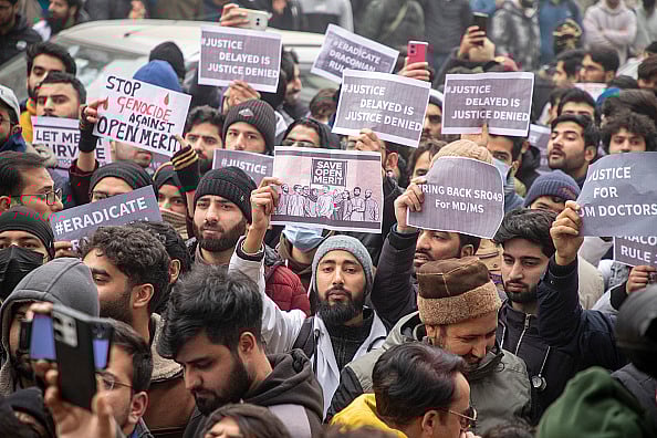 gettyimages : Kashmiri students hold placards during a protest outside the chief minister's residence on Srinagar's Gupkar Road |