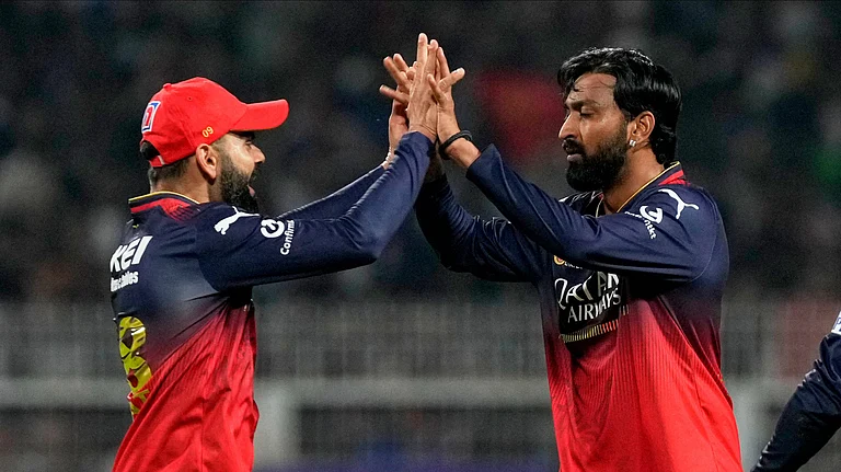 Royal Challengers Bengaluru's Krunal Pandya, right, celebrates with teammate Virat Kohli after the dismissal of Kolkata Knight Riders' Rinku Singh during the Indian Premier League cricket match between Kolkata Knight Riders and Royal Challengers Bengaluru at Eden Gardens in Kolkata. - AP Photo/Bikas Das