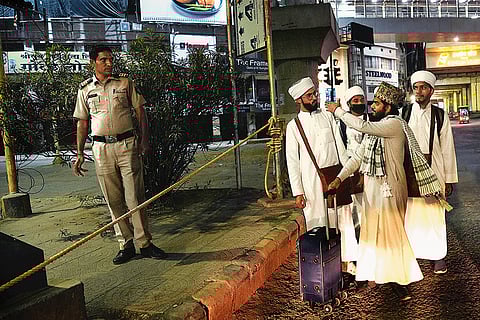 A policeman stops a group of Muslim religious students from entering the curfewed area in Nagpur