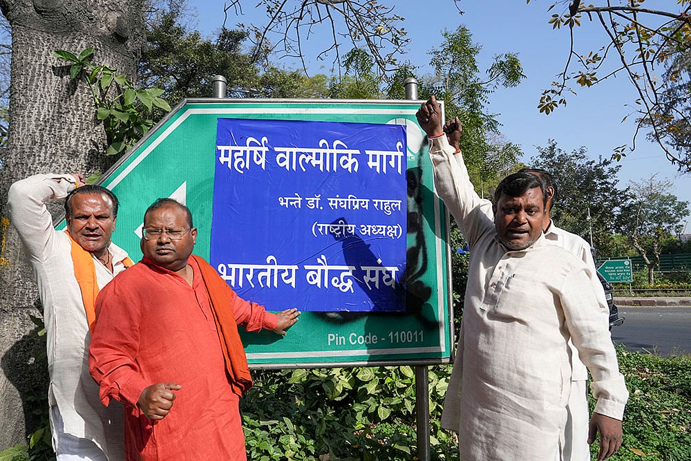 | Photo: PTI/Arun Sharma : Akbar Road signboard defaced