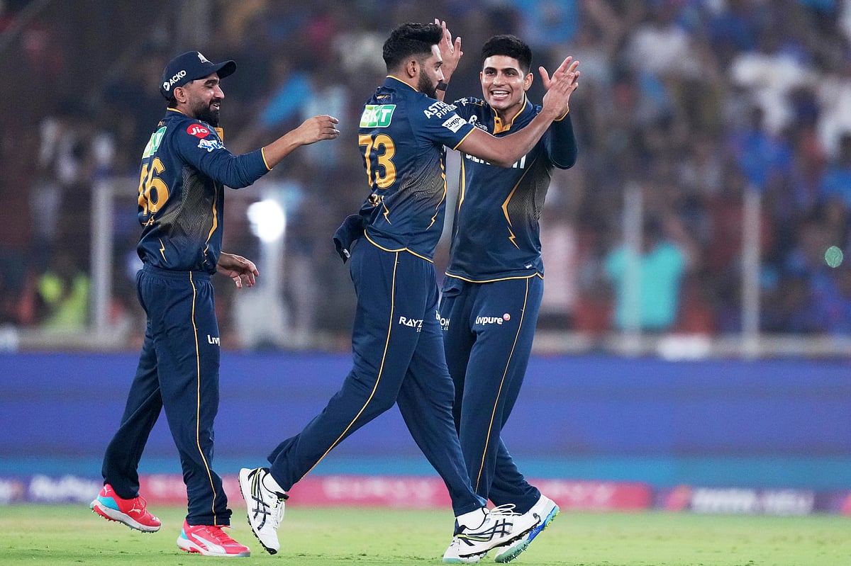 (AP Photo/Ajit Solanki) : Gujarat Titans' Mohammed Siraj, center, celebrates with captain Shubman Gill, right, and teammate Rahul Tewatia after the dismissal of Mumbai Indians' Rohit Sharma during the Indian Premier League cricket match between Gujarat Titans and Mumbai Indians at Narendra Modi Stadium in Ahmedabad, India, Saturday, March 29, 2025. 


