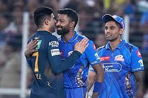 | Photo: AP/Ajit Solanki : MI captain Hardik Pandya hugs GT skipper Shubman Gill as Suryakumar Yadav looks on