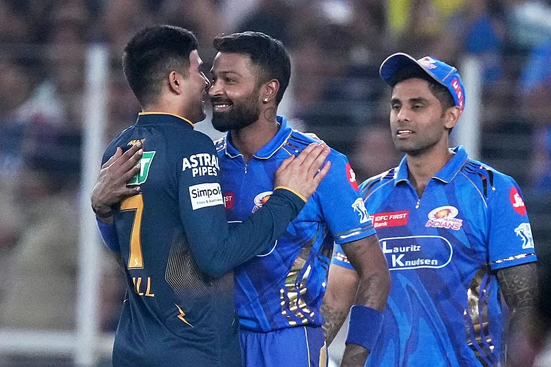 MI captain Hardik Pandya hugs GT skipper Shubman Gill as Suryakumar Yadav looks on
