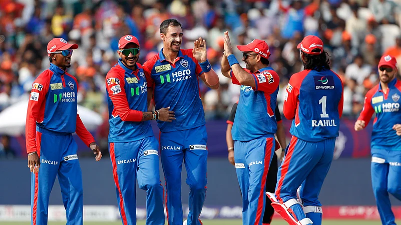 Delhi Capitals Mitchell Starc, center, celebrates the wicket. AP