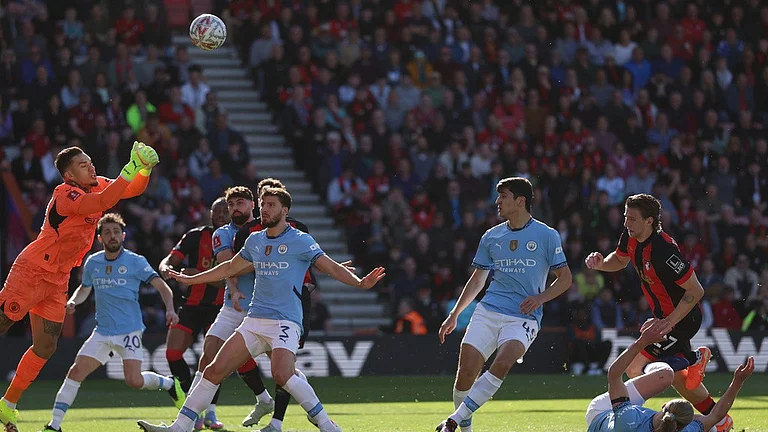 Ederson, left, makes a save during the English FA Cup quarterfinal soccer match between Bournemouth and Manchester City at the Vitality stadium in Bournemouth. - AP
