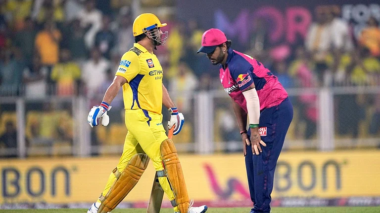 MS Dhoni walks out to bat. - AP/Anupam Nath