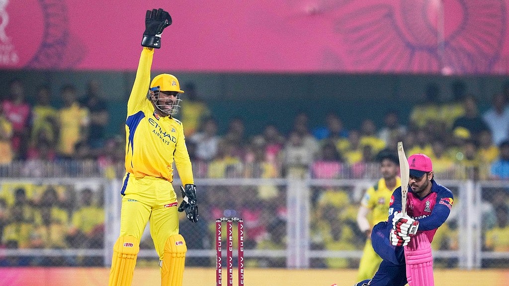 CSKs Mahendra Singh Dhoni, left, appeals for the wicket of RRs Nitish Rana