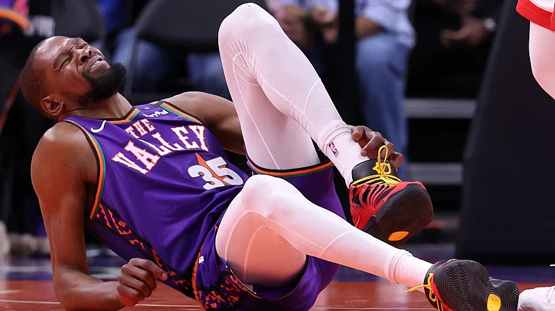 Phoenix Suns forward Kevin Durant grabs his injured ankle