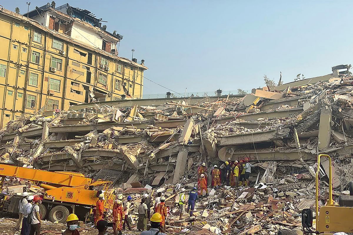 AP Photo/Thein Zaw : Rescuers work at the Sky Villa Condo that collapsed In Friday's earthquake in Mandalay, Myanmar, Sunday, March 30, 2025. 