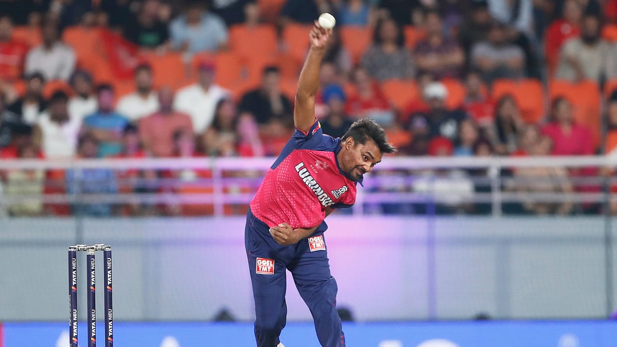 AP Photo/Surjeet Yadav : Rajasthan Royals' Sandeep Sharma bowls a delivery during the Indian Premier League cricket match between Punjab Kings and Rajasthan Royals at Maharaja Yadavindra Singh Cricket Stadium in Mohali.