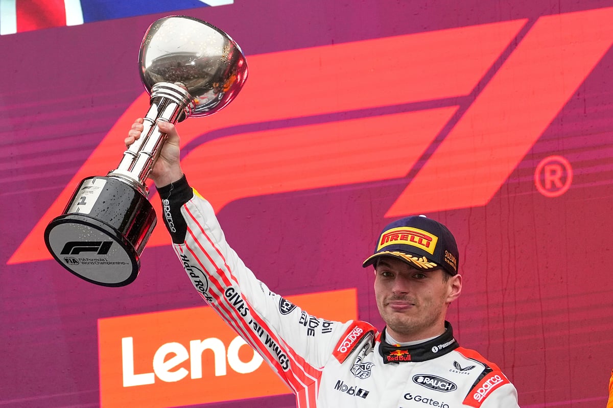 (AP Photo/Shuji Kajiyama) : Red Bull driver Max Verstappen of the Netherlands celebrates with his trophy on the podium after the Japanese Formula One Grand Prix at the Suzuka Circuit in Suzuka, central Japan, Sunday, April 6, 2025. 

