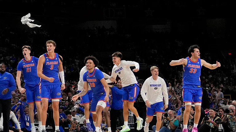 Florida celebrates their win against Auburn in the national semifinals at the Final Four of the NCAA college basketball tournament. - AP Photo/Brynn Anderson