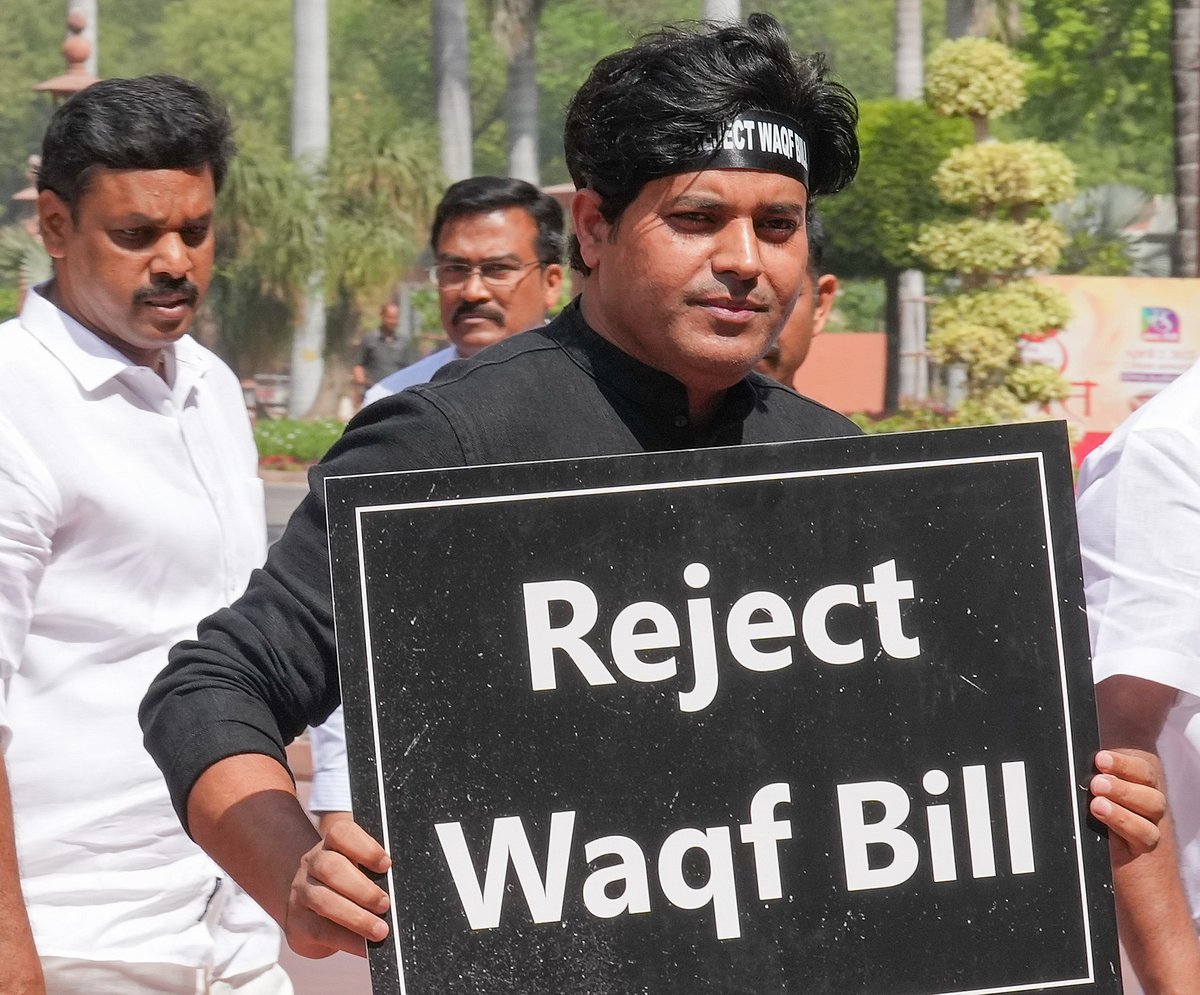Congress MP Imran Pratapgarhi stands outside Parliament holding a sign that says Reject Waqf Bill | - PTI