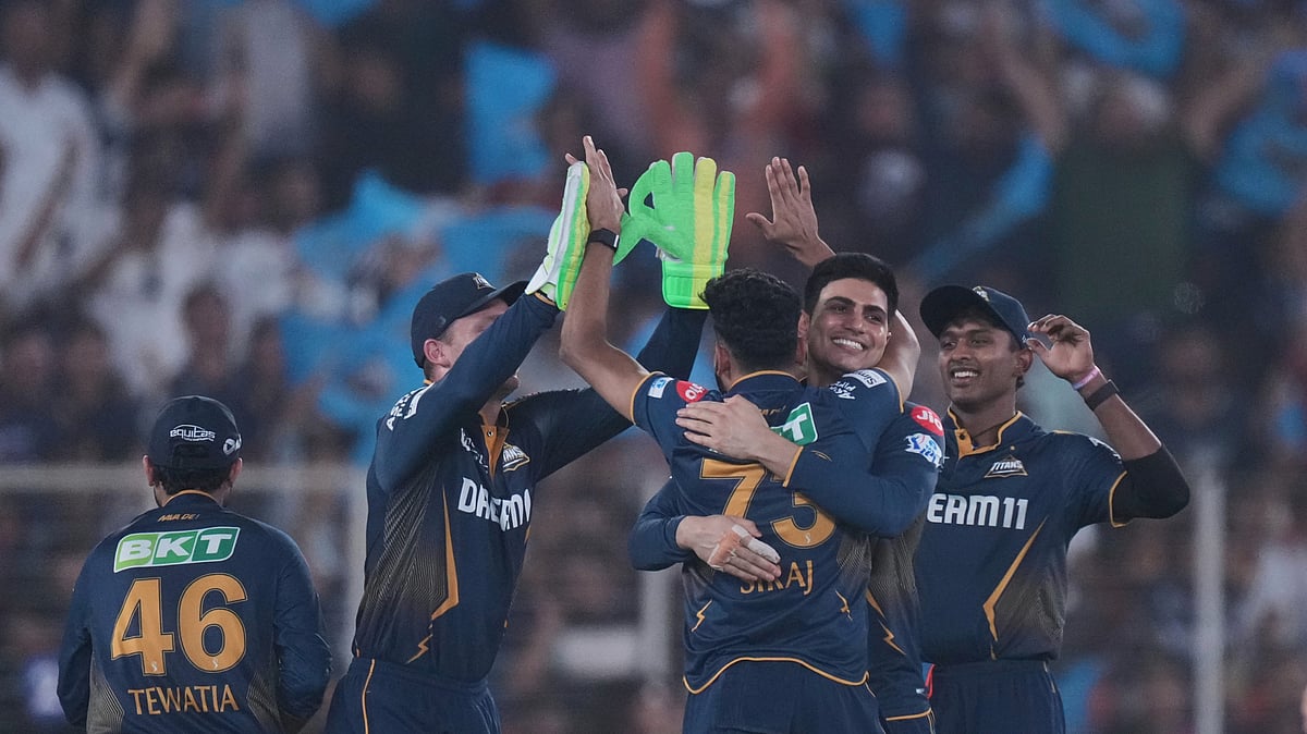 AP Photo/Ajit Solanki : Gujarat Titans' Mohammed Siraj and teammates celebrate the wicket of Rajasthan Royals' Nitish Rana during the Indian Premier League cricket match between Gujarat Titans and Rajasthan Royals at Narendra Modi Stadium in Ahmedabad.