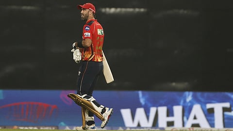 Punjab Kings' Glenn Maxwell walks off the field after losing his wicket during their Indian Premier League (IPL) 2025 match against Chennai Super Kings (CSK) in New Chandigarh on April 8, 2025.