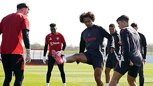 Martin Rickett/PA via AP : Manchester United's Joshua Zirkzee, centre, attends a training session ahead of the Europa League quarterfinal first leg soccer match against Lyon, at Trafford Training Centre, Carrington, England.