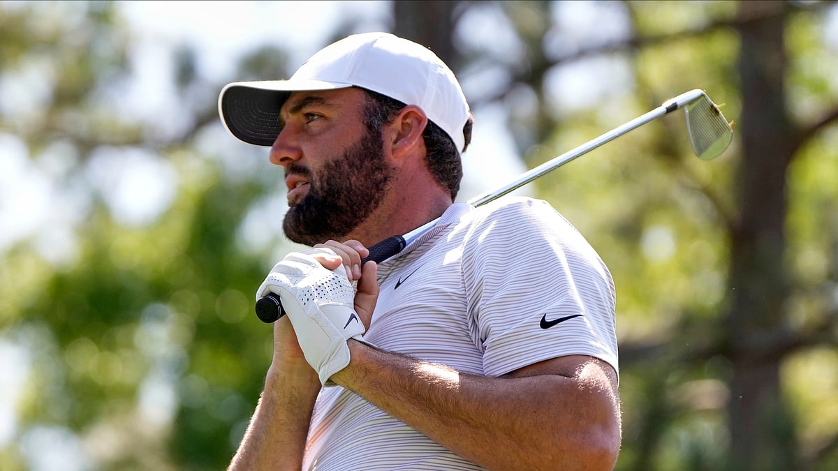 AP Photo/Julia Demaree Nikhinson : Scottie Scheffler watches his tee shot on the sixth hole during the first round at the Masters golf tournament.