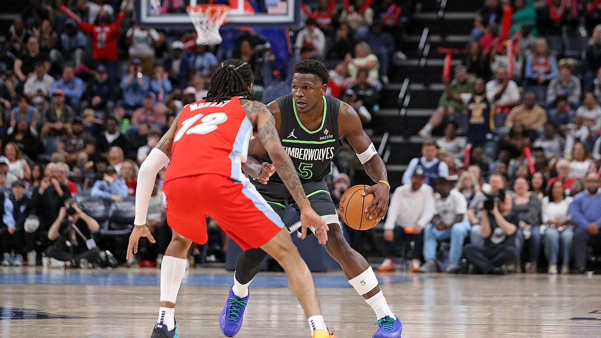 Anthony Edwards #5 of the Minnesota Timberwolves handles the ball against Ja Morant #12 of the Memphis Grizzlies during the first half at FedExForum on April 10, 2025 in Memphis, Tennessee.