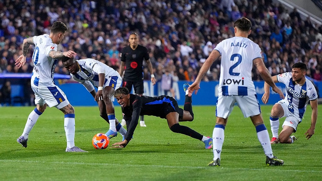 AP/Manu Fernandez : Lamine Yamal, centre, and Leganes' Yan Diomande, centre left, challenge for the ball during the Spanish La Liga soccer match between CD Leganes and Barcelona