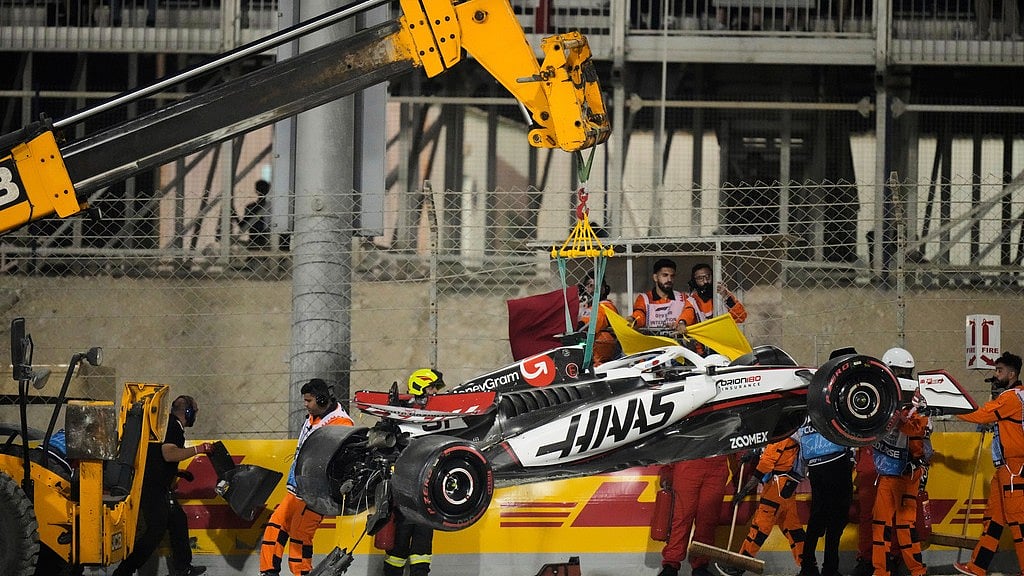 Photo: AP : The Haas car of driver Esteban Ocon is removed from the track after a crash during the qualifying for the Formula One 2025 Bahrain Grand Prix, in Sakhir.
