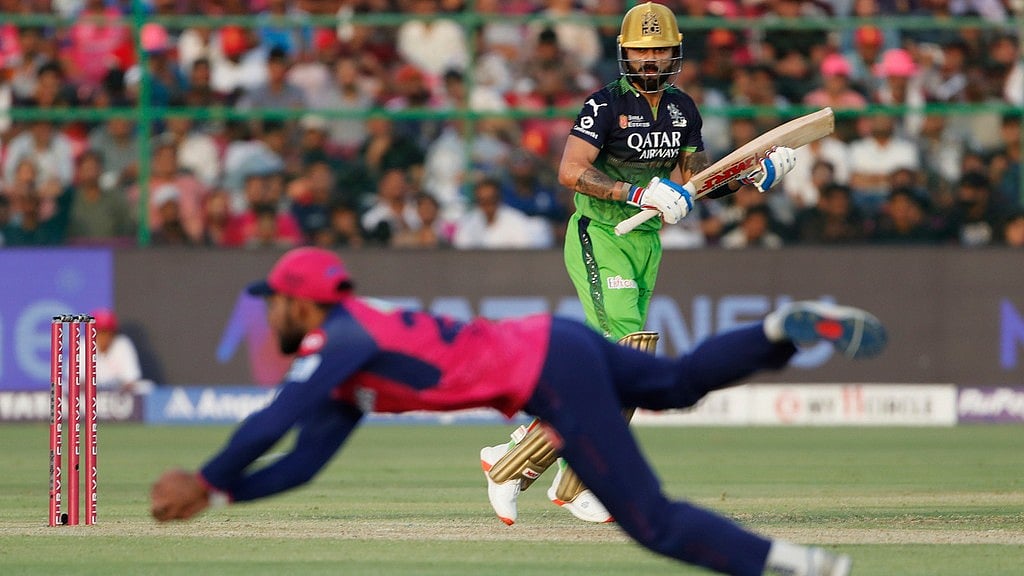 Virat Kohli watches as Rajasthan Royals' Dhruv Jurel fields a ball during the Indian Premier League cricket match between Rajasthan Royals and Royal Challengers Bengaluru - AP/Surjeet YADAV