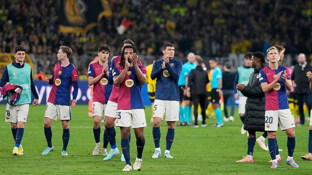 Photo: AP : Barcelona players greet supporters at the end of the Champions League quarter-final second-leg match against Borussia Dortmund. 