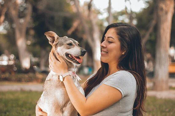 A women embracing a dog