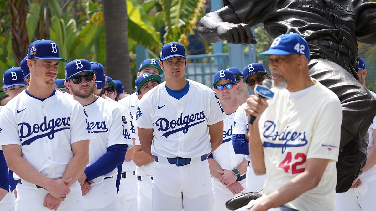 | AP Photo/Damian Dovarganes : Los Angeles Dodgers' Shohei Ohtani, center, and teammates listen to former NBA player Kareem Abdul-Jabbar during an event to commemorate Jackie Robinson Day in Los Angeles on April 15, 2025.