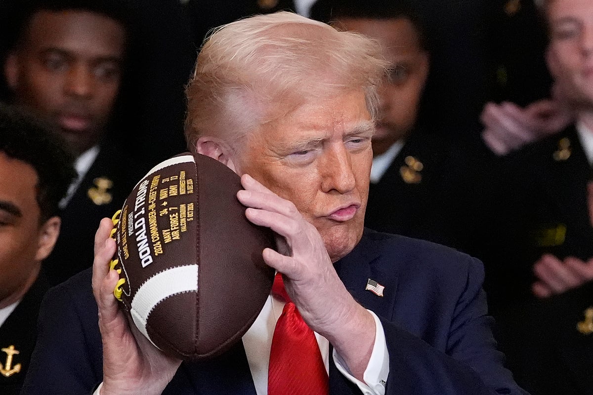 AP/Alex Brandon : Donald Trump holds a football during the Commander-in-Chief Trophy presentation to the Navy Midshipmen football team in the East Room of the White House in Washington on April 15, 2025.